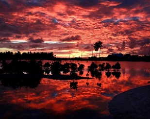 Villagers watch the sunset over a small lagoon near the village of Tangintebu on South Tarawa. The project would involve building the land masses up with sand and gravel. (David Gray/Reuters)