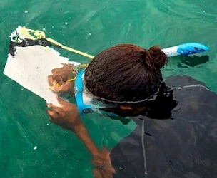 A marine research officer, working with the National Parks Authority, in mapping coral reefs in the waters around Mahe island in Seychelles. Credit - Ryan Brown / UN Women / CC BY-NC-ND