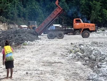A woman at the Ruarata log pond in East Are'Are. credit - Jan van der Ploeg