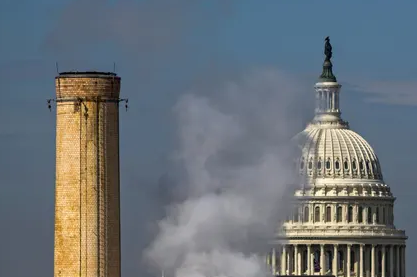 The dome of the US Capitol is seen behind the smokestacks of the Capitol Power Plant, a coal-burning plant in Washington DC. Photograph: Jim Lo Scalzo/EPA