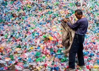A Chinese labourer sorting out plastic bottles on the outskirt of Beijing. Photograph: Fred Dufour/AFP/Getty Images
