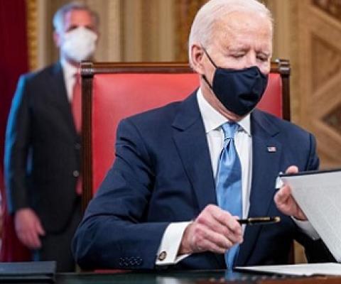 President Biden signing exective orders. Source - www.rnz.co.nz