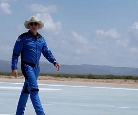 Billionaire Jeff Bezos walks on the tarmac near the Blue Origin rocket that took him to space on July 20. Joe Raedle/Getty Images