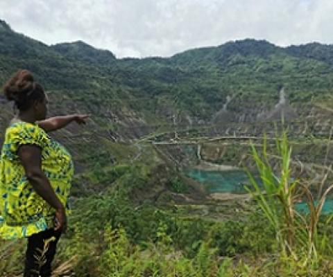 Theonila Roka Matbob stands in front of the Pangua mine in Konawiru, Bougainville. Photograph: Human Rights Law Centre/Reuters
