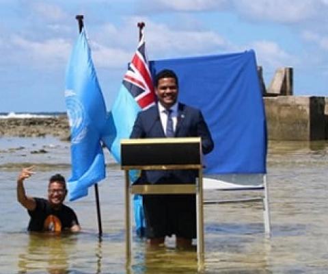 Tuvalu’s Minister for Justice, Communication & Foreign Affairs Simon Kofe gives a COP26 statement while standing in the ocean in Funafuti, Tuvalu November 5, 2021. Tuvalu Foreign Ministry | via Reuters
