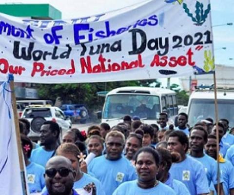Students of the School of Fisheries and Marine Studies at Solomon Islands National University march under a banner celebrating the worth of tuna during a World Tuna Day parade in Honiara. Photo: Ronald F. Toito’ona.