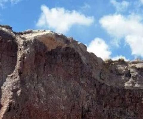 URI graduate student Reilly Hayes (left) and undergraduate Amanda Bednarick examine an outcrop for fossils at Petrified Forest National Park as part of their research. Credit: Amanda Bednarick