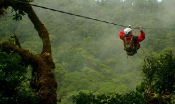  visitor zip-lines above the tree canopy in Costa Rica’s Monteverde National Park; the country is among those where ecotourism initiatives have been adversely impacted by the pandemic. (iStock)