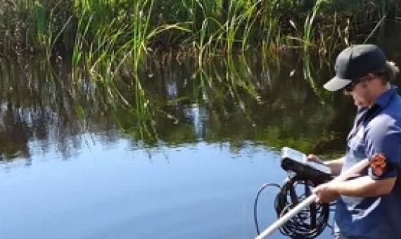A NSW environment officer collects data at Bengello near Batemans Bay. Water in estuaries has warmed at a much faster rate than the atmosphere or oceans, a study has found. Photograph: New South Wales Department of Planning, Industry and Environment