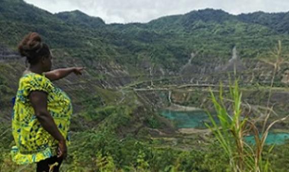 Theonila Roka Matbob stands in front of the Pangua mine in Konawiru, Bougainville. Photograph: Human Rights Law Centre/Reuters