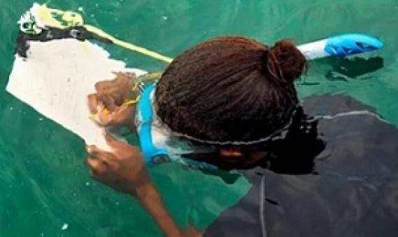A marine research officer, working with the National Parks Authority, in mapping coral reefs in the waters around Mahe island in Seychelles. Credit - Ryan Brown / UN Women / CC BY-NC-ND