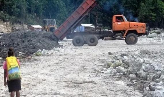 A woman at the Ruarata log pond in East Are'Are. credit - Jan van der Ploeg
