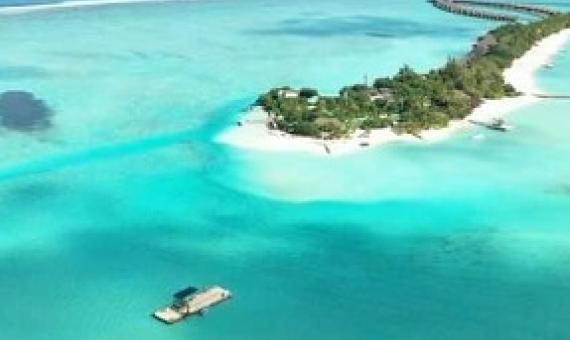 In the lower left corner of this photograph, researchers prepare a submersible device. “Together with our collaborators in the Maldives, we are designing, testing, building, and deploying submersible devices that, based simply on their geometry in relationship to the ocean waves and currents, promote sand accumulation in specific areas,” says associate professor Skylar Tibbits. Credit: Massachusetts Institute of Technology