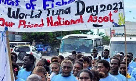 Students of the School of Fisheries and Marine Studies at Solomon Islands National University march under a banner celebrating the worth of tuna during a World Tuna Day parade in Honiara. Photo: Ronald F. Toito’ona.
