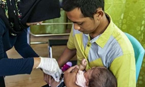 A nurse gives a baby an immunization at a healthcare clinic on the edge of the Gunung Palung National Park in West Kalimantan, Indonesia. Credit: Stephanie Gee