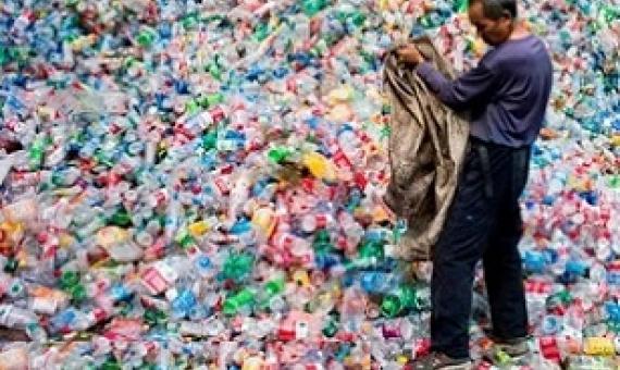 A Chinese labourer sorting out plastic bottles on the outskirt of Beijing. Photograph: Fred Dufour/AFP/Getty Images